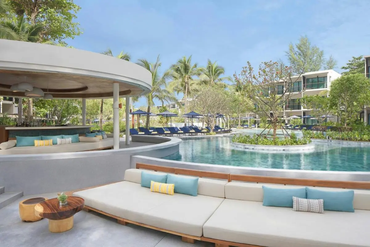 Spacious Outdoor Pool Area with Lounge Seating and Tropical Landscaping at Mai Khao Beach