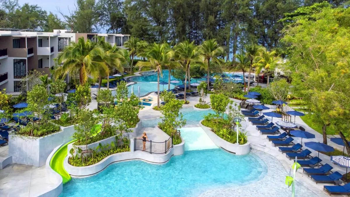 Spacious Outdoor Pool Area with Water Slide and Lounge Chairs Near Mai Khao Beach