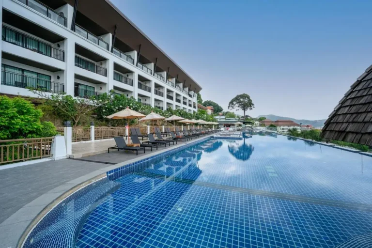 Spacious Outdoor Swimming Pool and Jacuzzi Area with Lounge Chairs and Modern Architecture at Patong Beach