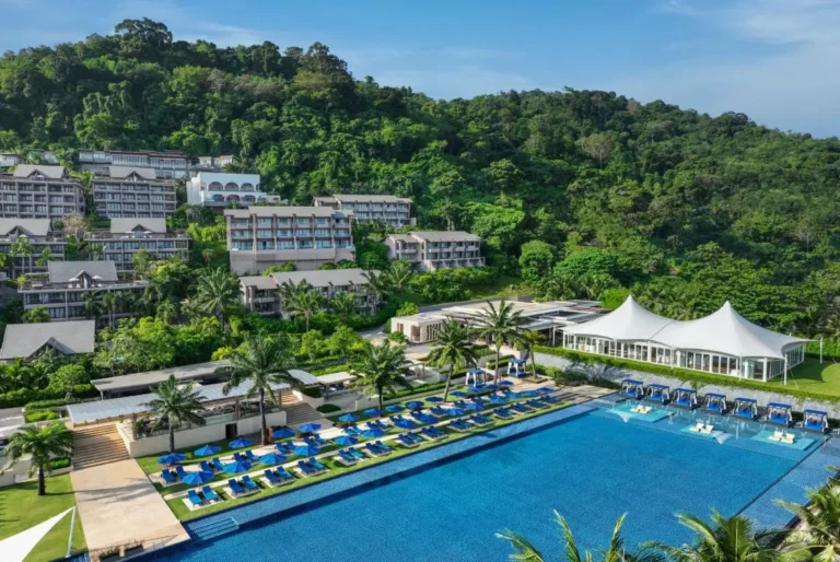 Spacious Outdoor Swimming Pool Area with Lounge Chairs and Shaded Cabanas at Kamala Beach