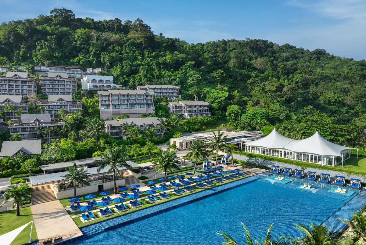 Spacious Outdoor Swimming Pool Area with Lounge Chairs and Shaded Cabanas at Kamala Beach