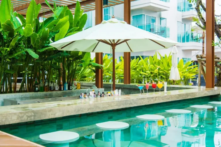 Swim-Up Bar with Submerged Stools and Tropical Foliage at Patong Beach Pool