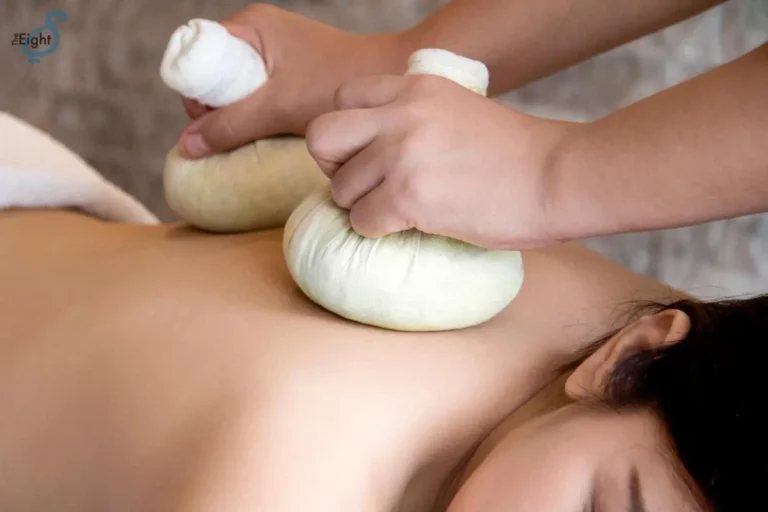 Traditional Herbal Compress Massage Therapy in a Relaxing Spa Setting in Pathumwan