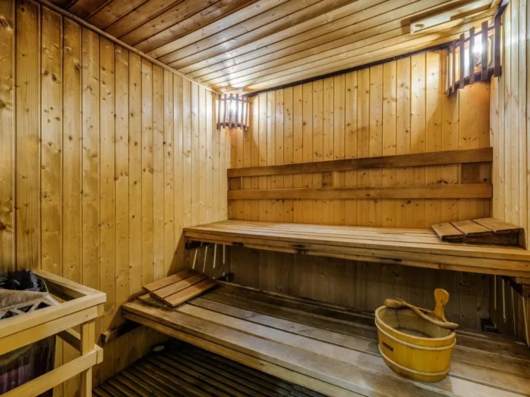 Traditional Wooden Sauna Room with Heater and Benches in Bang Rak Bangkok