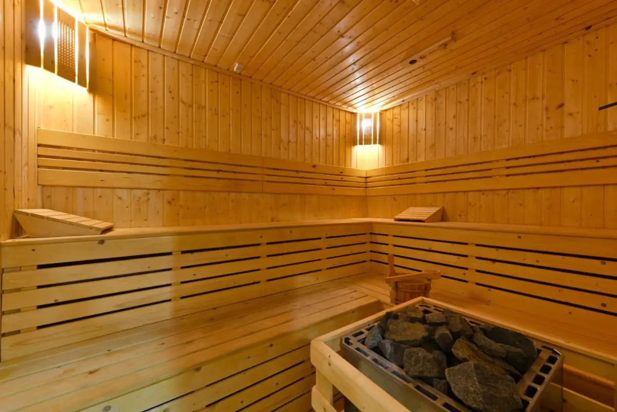 Traditional Wooden Sauna Room with Heater and Tiered Seating in Pathumwan Bangkok