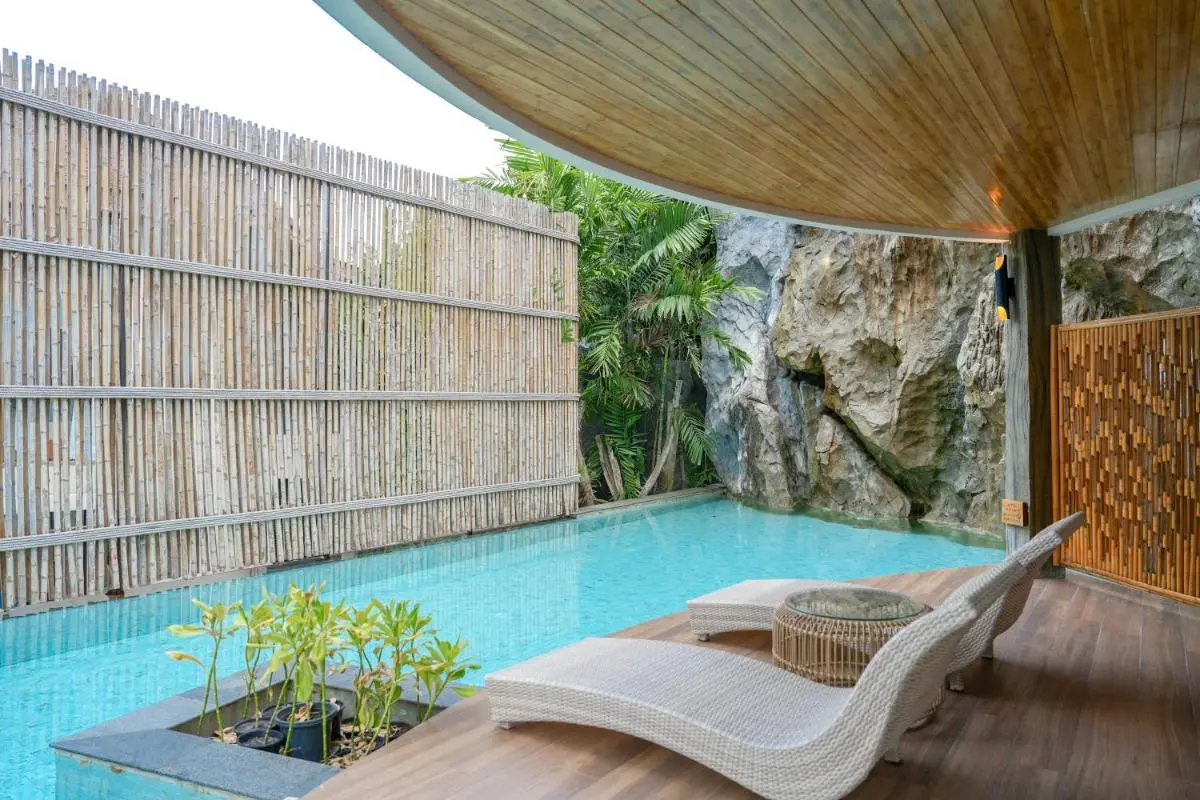 Tranquil Covered Outdoor Area with Rectangular Swimming Pool and Bamboo Privacy Fence in Phuket Town