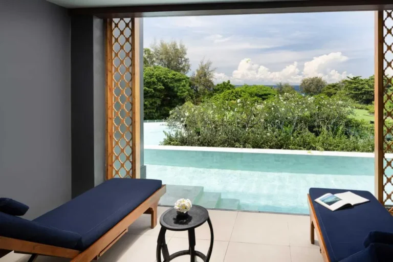 Tranquil Indoor-Outdoor Lounge and Shallow Pool Area with Garden View at Karon Beach
