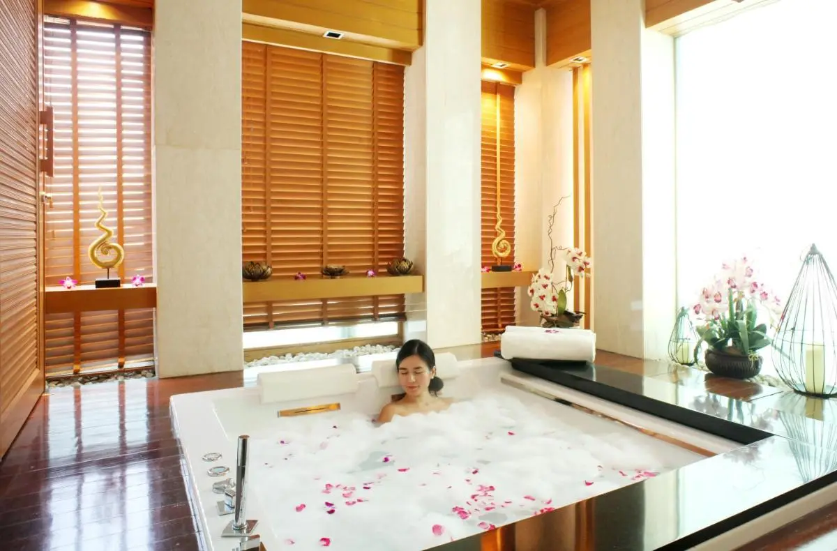 Tranquil Indoor Spa Area with Jacuzzi Tub and Natural Light in Pathumwan