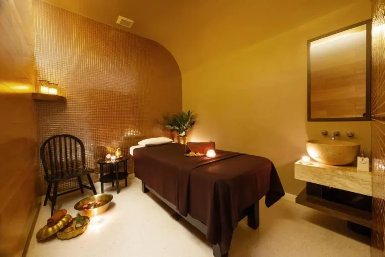 Tranquil Indoor Spa Treatment Room with Massage Table and Stone Sink in Pathumwan
