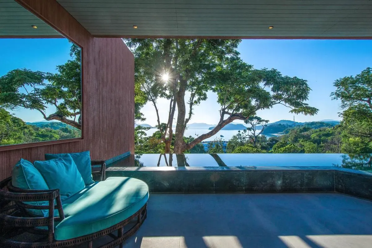 Tranquil Outdoor Infinity Pool and Lounge Area Overlooking Panwa Beach Landscape