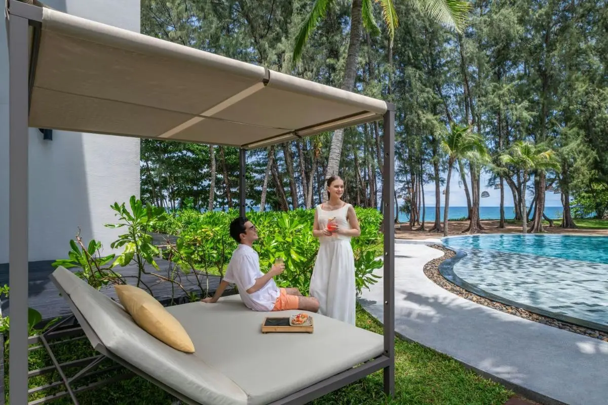 Le Meridien Phuket Mai Khao Beach Resort Tranquil Outdoor Pool and Relaxation Area with Ocean View at Mai Khao Beach