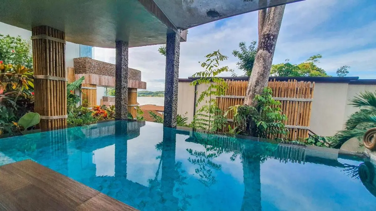 Tranquil Outdoor Pool Area with Bamboo Accents and Tropical Surroundings in Phuket Town