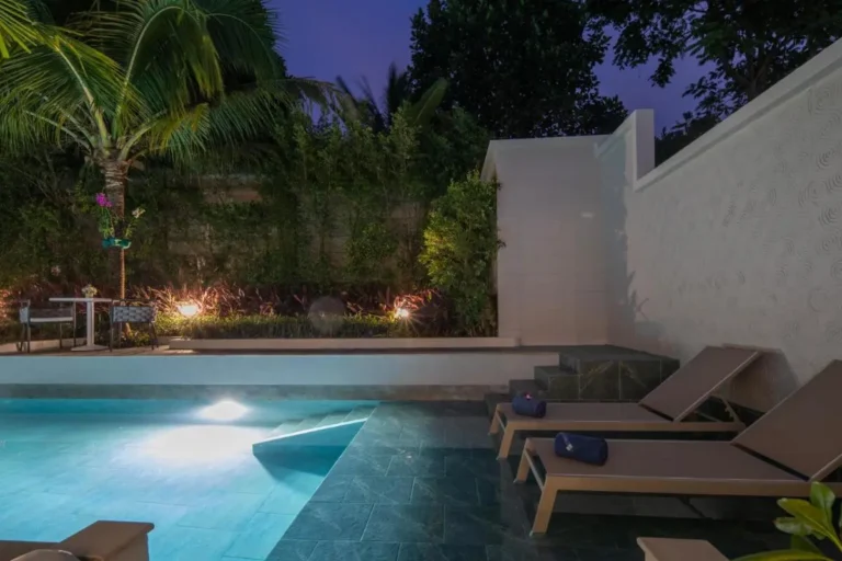 Tranquil Outdoor Pool Area with Lounge Seating and Garden in Phuket Town