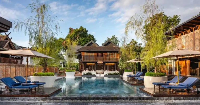 Tranquil Outdoor Pool Area with Lounge Seating and Wooden Deck in Chiang Mai