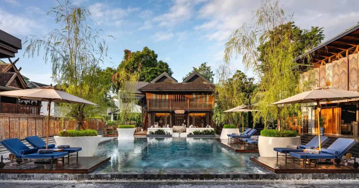Tranquil Outdoor Pool Area with Lounge Seating and Wooden Deck in Chiang Mai