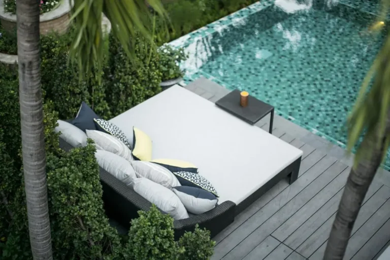 Tranquil Outdoor Pool Area with Mosaic Tiles and Cushioned Daybed in Phra Nakhon