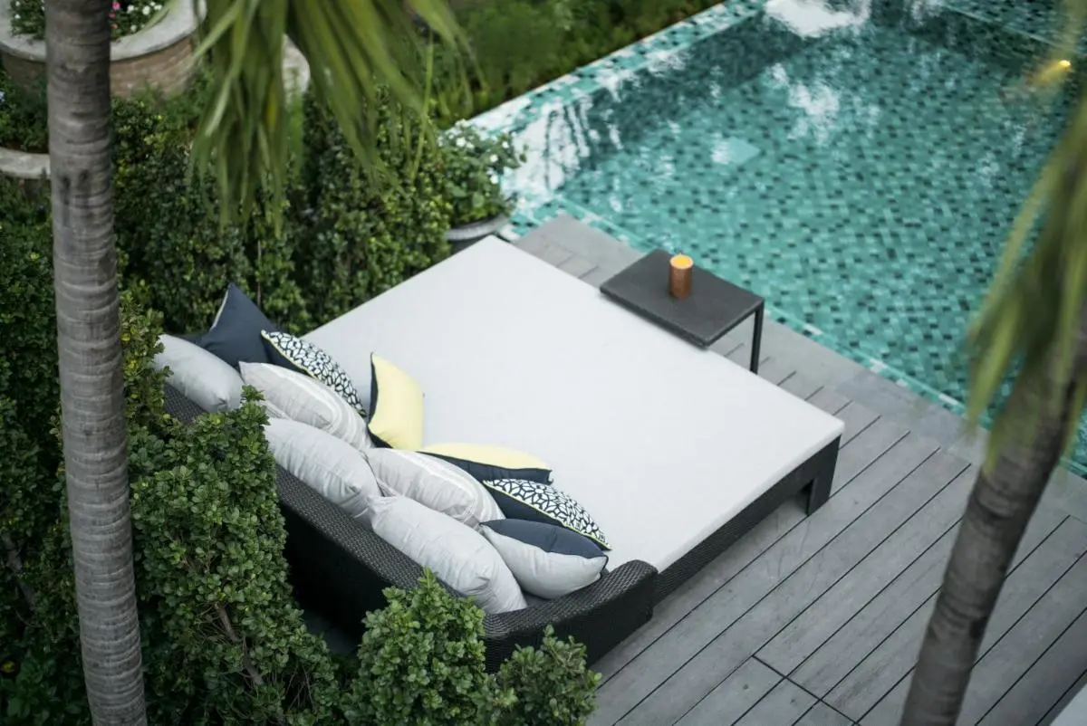 Tranquil Outdoor Pool Area with Mosaic Tiles and Cushioned Daybed in Phra Nakhon