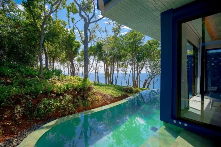 Tranquil Outdoor Pool Area with Ocean View and Modern Architecture at Panwa Beach