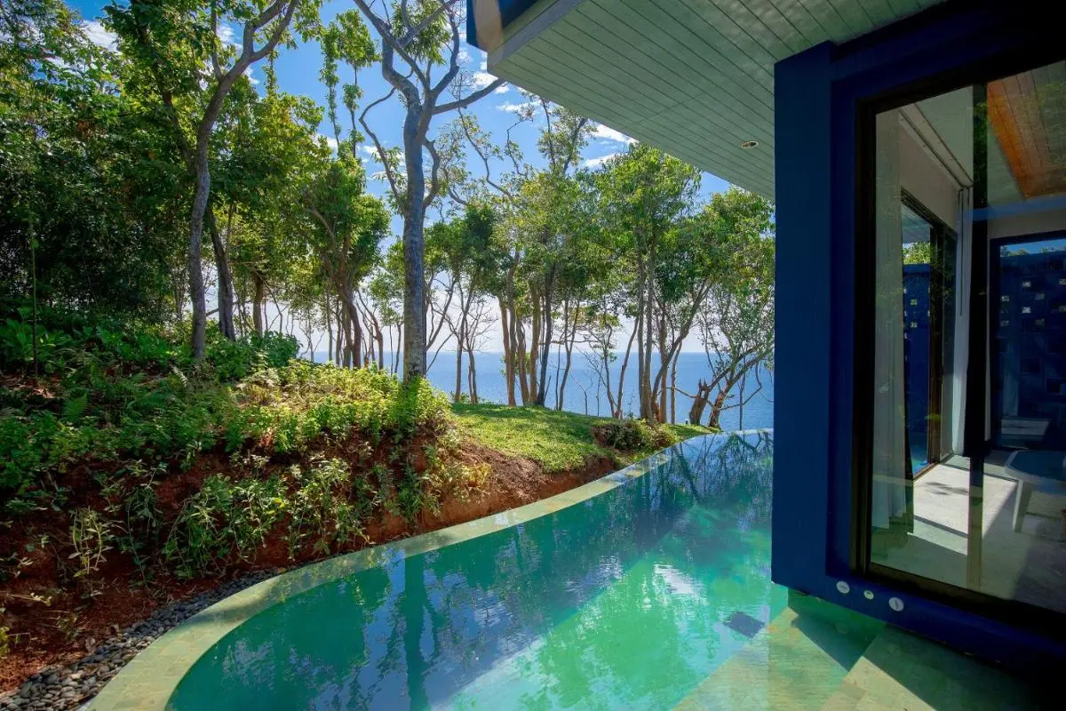 Tranquil Outdoor Pool Area with Ocean View and Modern Architecture at Panwa Beach