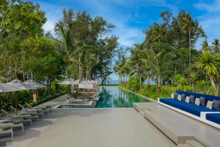 Tranquil Outdoor Pool Area with Ocean View and Tropical Landscaping at Mai Khao Beach