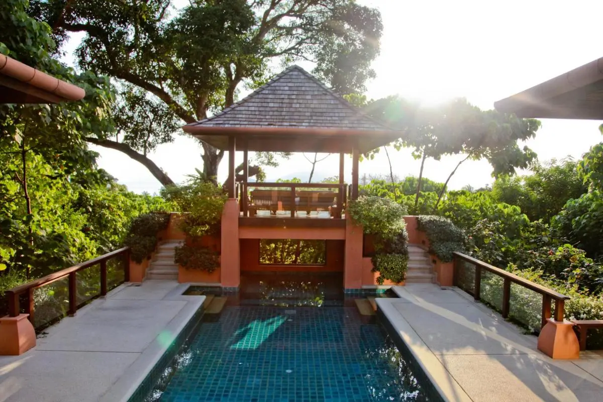 Tranquil Outdoor Pool Area with Pavilion and Glass Railings at Panwa Beach