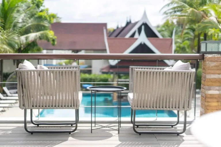 Tranquil Outdoor Seating Area Overlooking Rectangular Pool with Tropical Greenery in Thalang