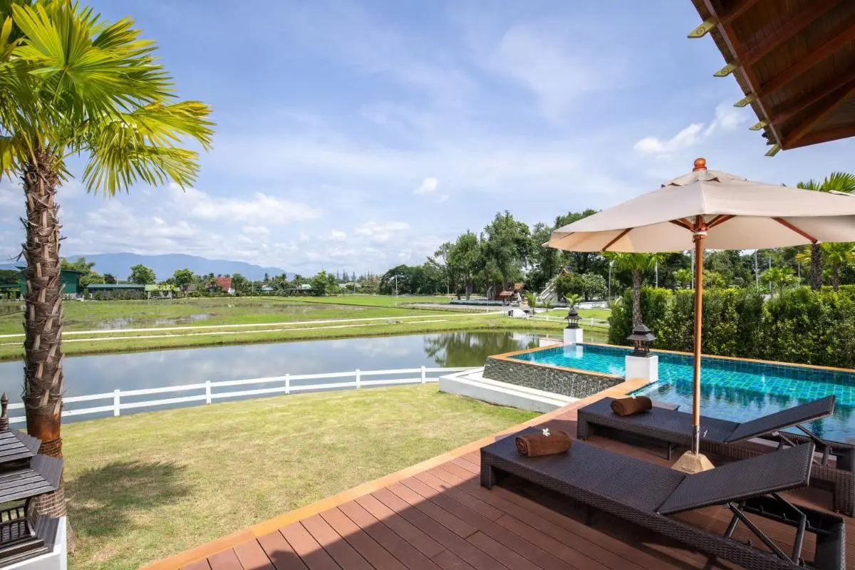 Tranquil Outdoor Swimming Pool and Lounge Area Overlooking Scenic Water and Mountains in Chiang Mai