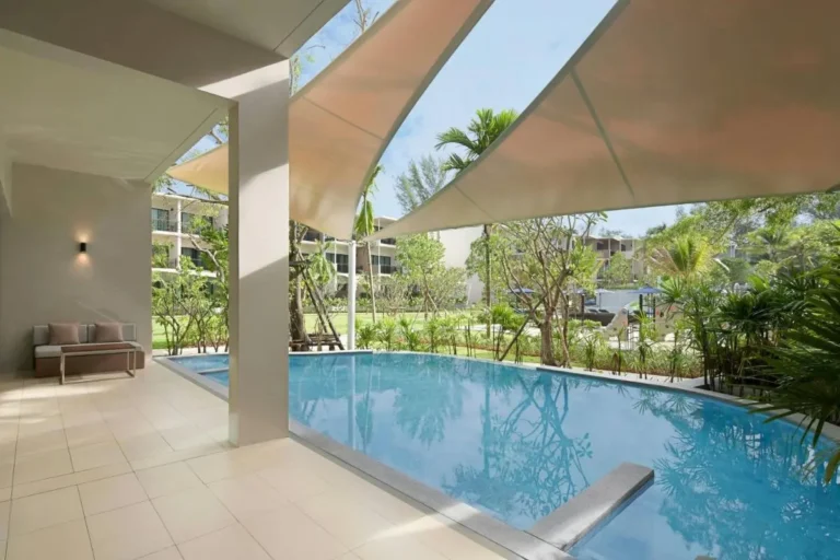 Tranquil Outdoor Swimming Pool and Patio Area with Garden Views at Mai Khao Beach