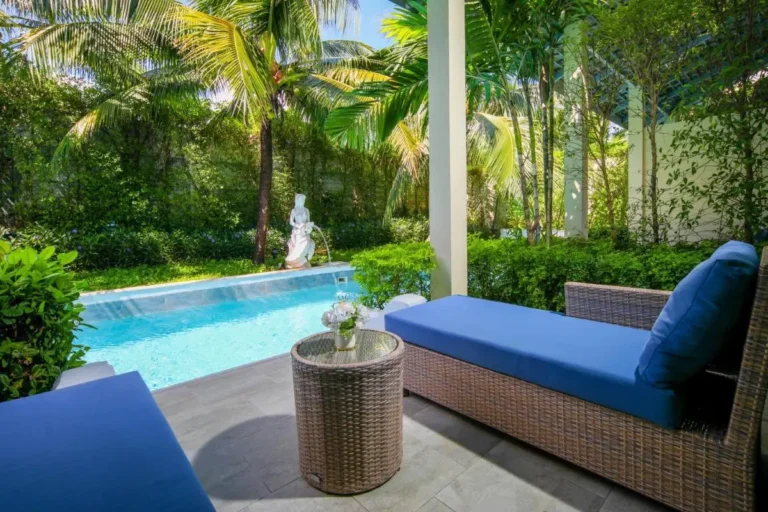 Tranquil Outdoor Swimming Pool Area with Water Feature and Tropical Plants in Phuket Town