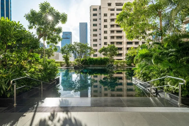 Tranquil Outdoor Swimming Pool Surrounded by Greenery in Pathumwan Urban Setting
