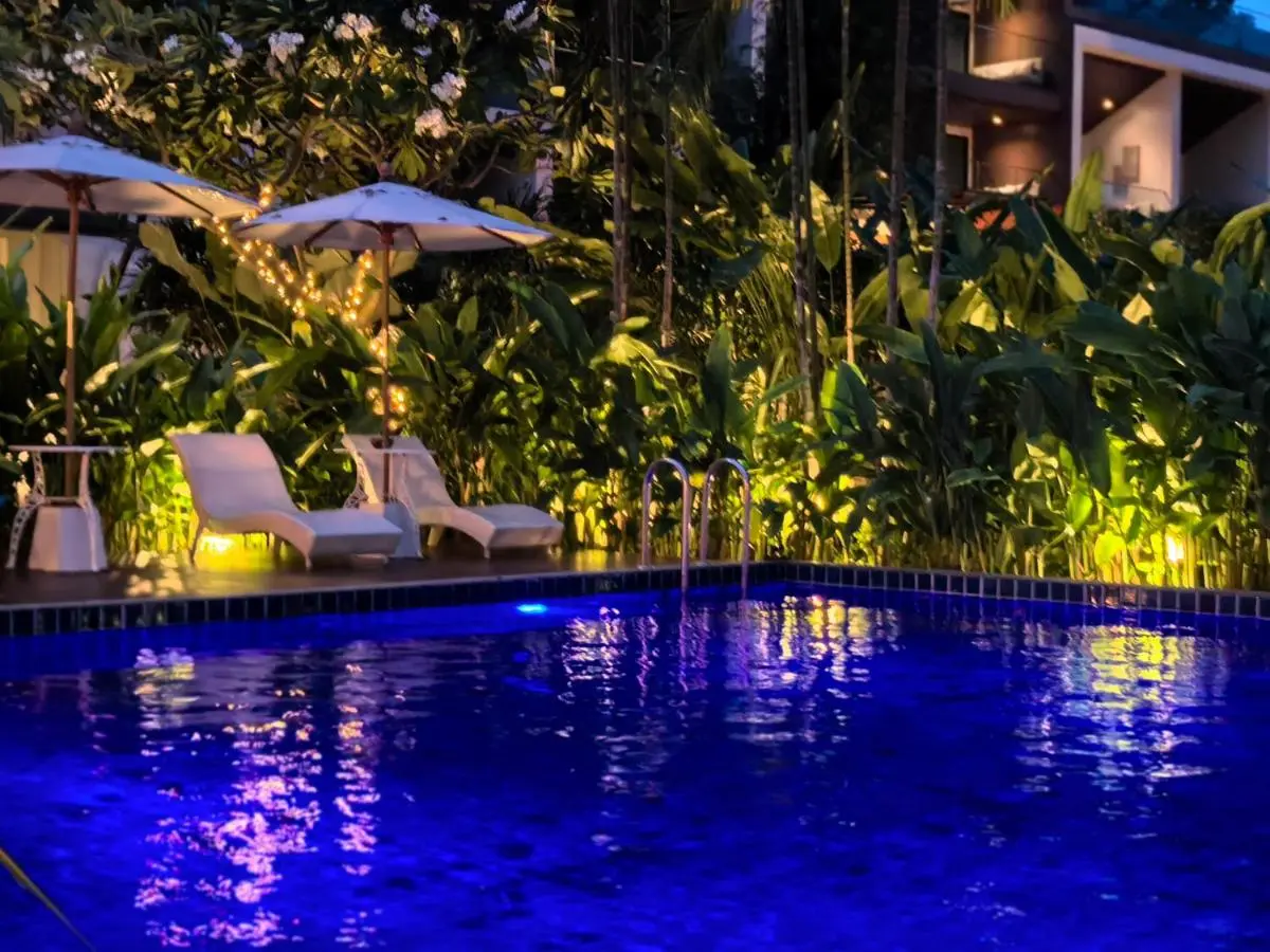 Tranquil Outdoor Swimming Pool with Lounge Area and Tropical Foliage in Wat Ket Chiang Mai