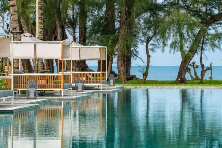 Tranquil Outdoor Swimming Pool with Modern Cabanas Overlooking Mai Khao Beach