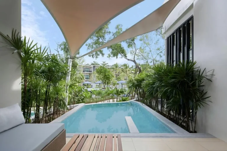 Tranquil Semi-Enclosed Pool Area with Shaded Seating and Tropical Greenery at Mai Khao Beach