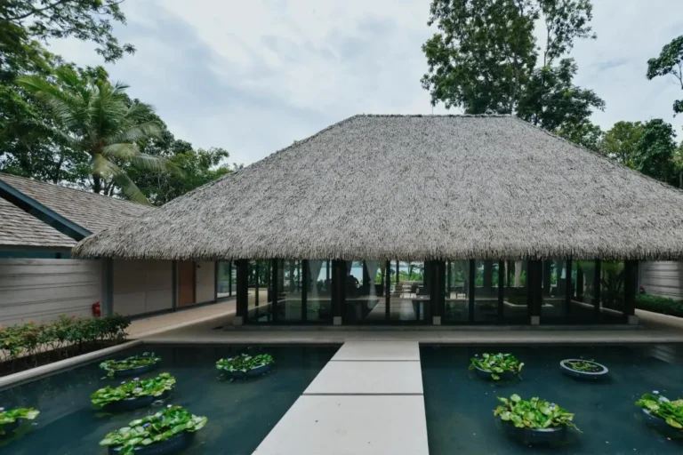 Tranquil Tropical Pool and Spa Area with Thatched Roof Structure in Phuket Town