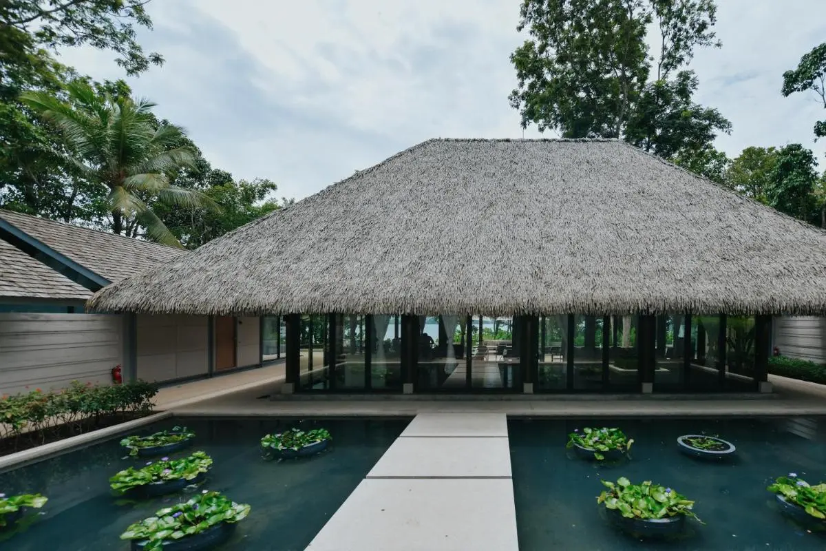 Tranquil Tropical Pool and Spa Area with Thatched Roof Structure in Phuket Town
