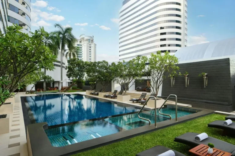 Urban Outdoor Pool and Spa Area with Lounge Seating in Khlong Toei Cityscape