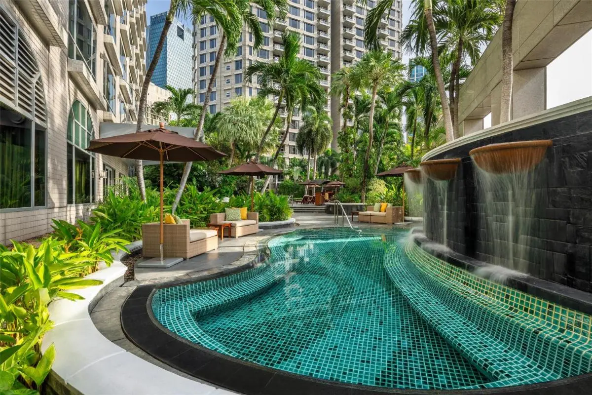 Urban Outdoor Pool Area with Jacuzzi and Tropical Landscaping in Pathumwan Bangkok