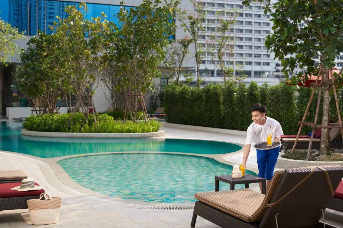Urban Outdoor Pool Area with Lounge Chairs and Greenery in Ratchathewi Bangkok