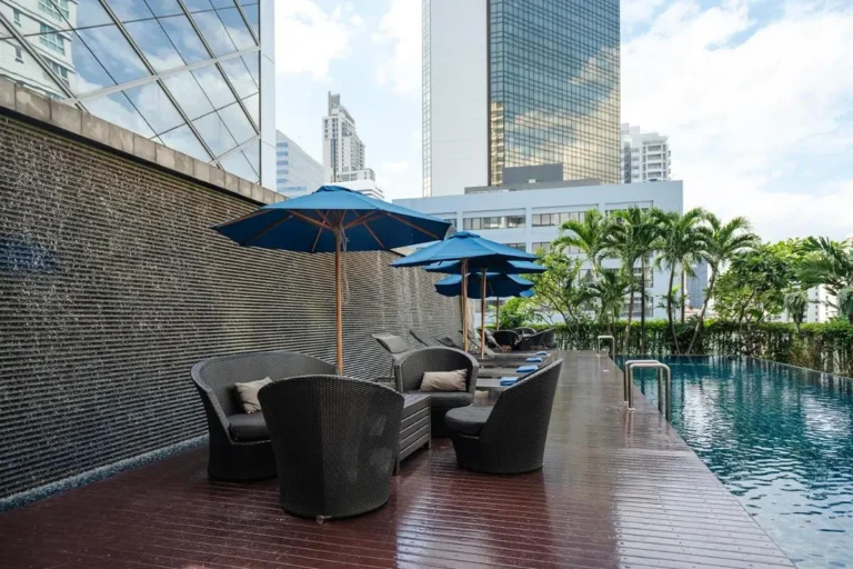 Urban Outdoor Pool Area with Lounge Seating and Water Feature in Wattana Bangkok