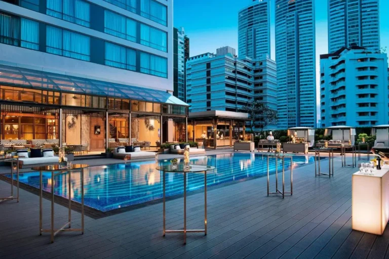 Urban Outdoor Pool Terrace with Lounge Seating and Bar Area in Khlong Toei Bangkok