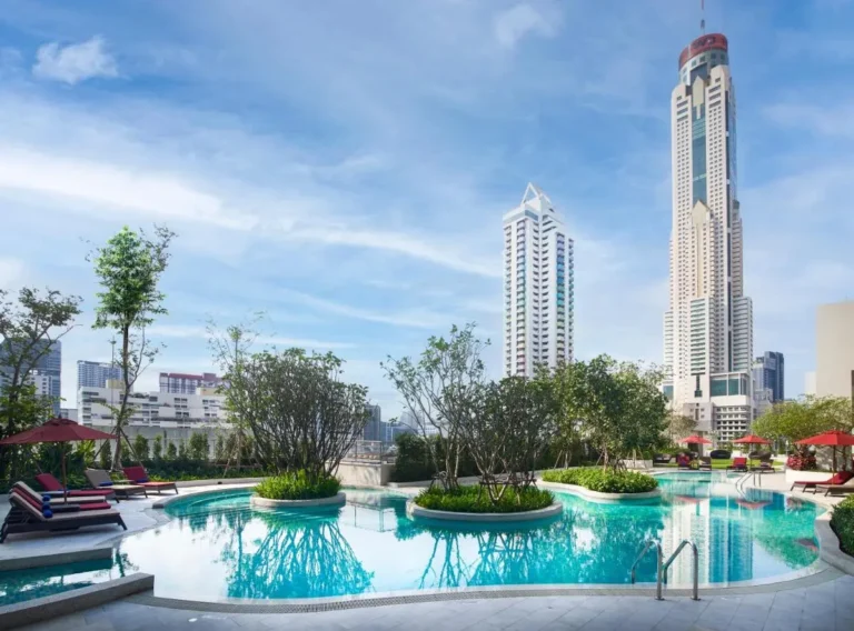 Urban Outdoor Swimming Pool with Greenery and Lounge Area in Ratchathewi Bangkok