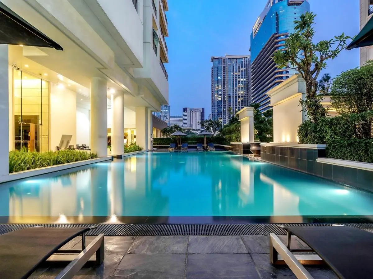 Urban Outdoor Swimming Pool with Lounge Area and Cityscape Views in Pathumwan Bangkok