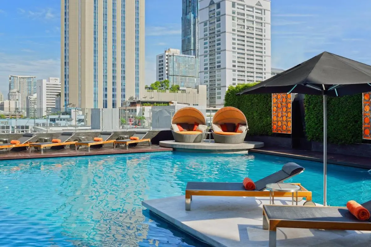 Urban Rooftop Pool Area with Lounge Seating and Vertical Garden in Wattana Bangkok