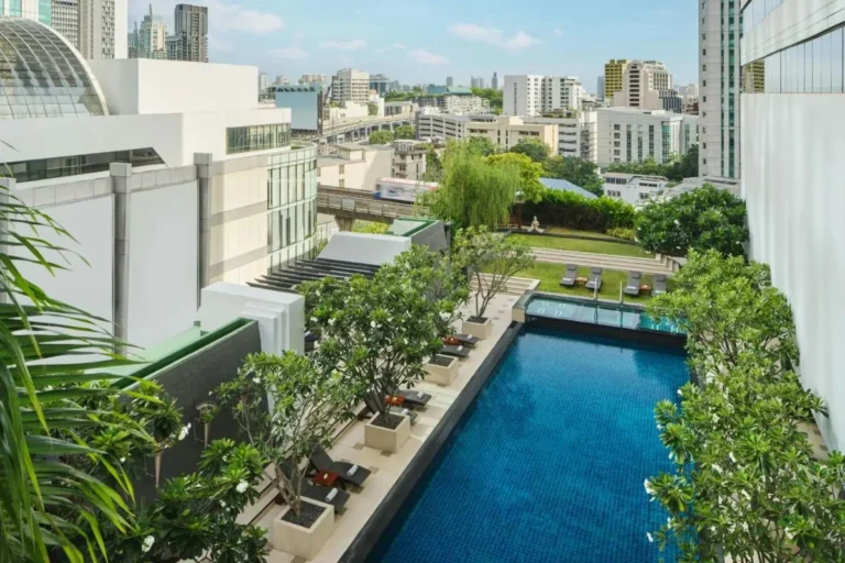 Urban Rooftop Swimming Pool and Relaxation Area with City Views in Khlong Toei Bangkok